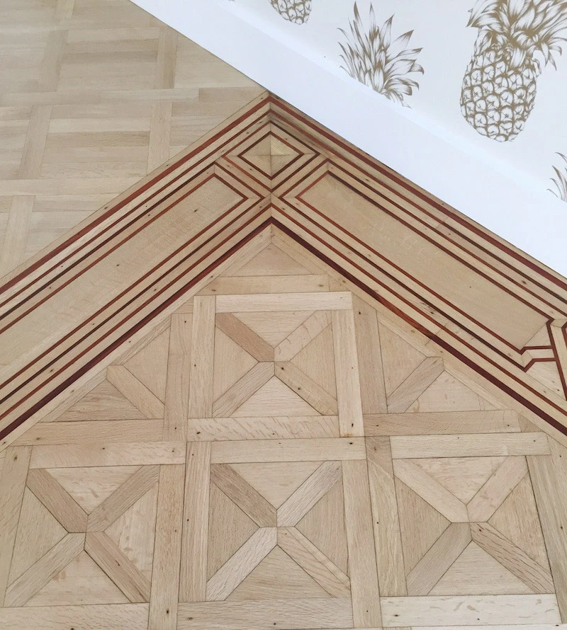 Pièce vide en cours de rénovation avec murs blancs fraîchement peints et fenêtre à châssis noir